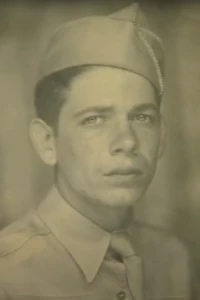 a black and white photo of Tommy in uniform wearing a hat